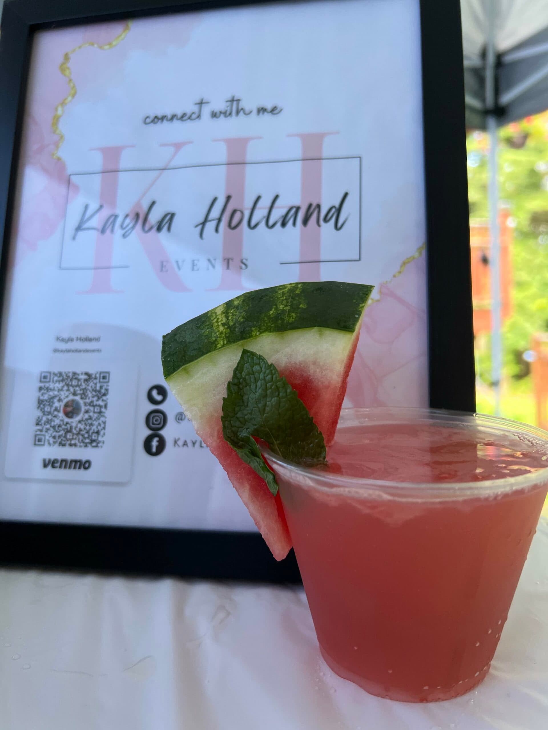 A watermelon cocktail in front of a framed 'connect with me' sign